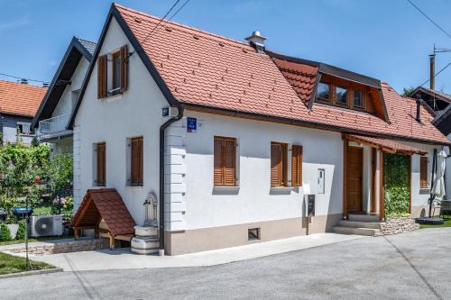 a small white house with a red roof at House Majda in Zagreb