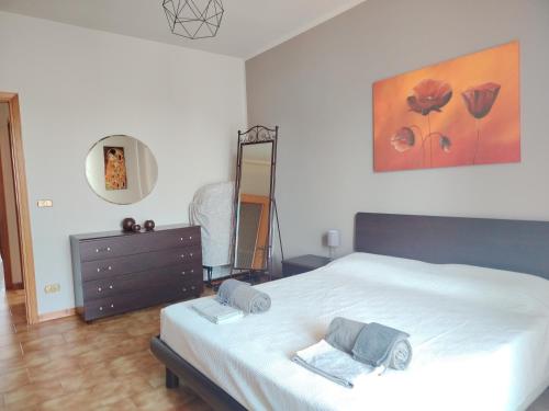 a bedroom with a bed and a dresser and a mirror at Appartamento Laura in Quargnento