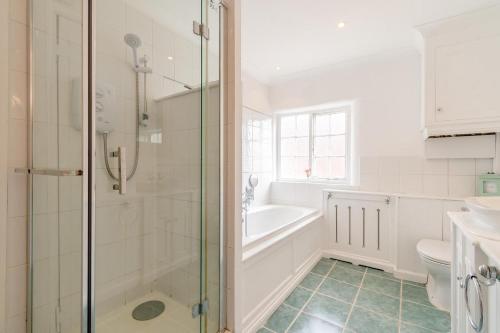 a bathroom with a shower and a tub and a sink at 2 Bed in Newark oc-o36894 in Newark-on-Trent