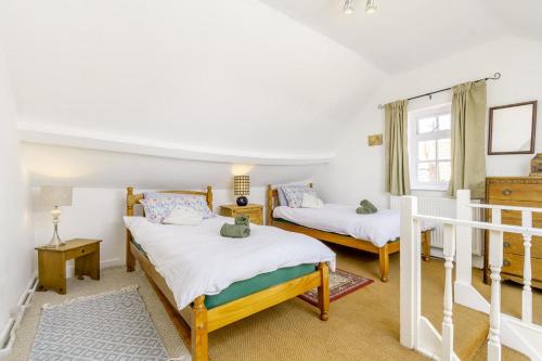a bedroom with two beds and a staircase at 2 Bed in Newark oc-o36894 in Newark-on-Trent