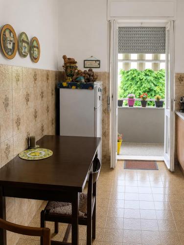 a kitchen with a table and a refrigerator at Room between Milan and Como in Seregno