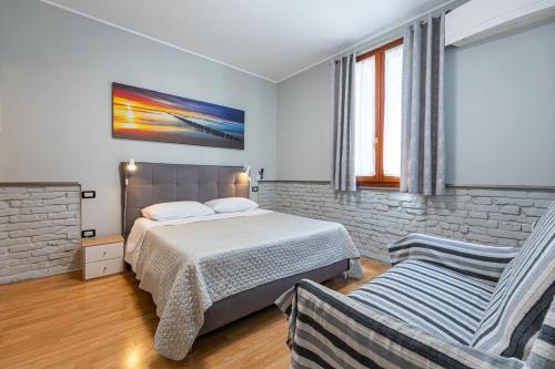 a bedroom with a bed and a chair at My Tiny Home Venice in Marghera