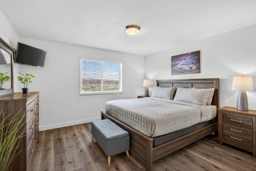 a bedroom with a bed and a television at Moab Redcliff Condos in Moab