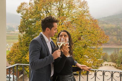 a man and a woman holding a glass of wine at Hotel Lilla' in Terlago