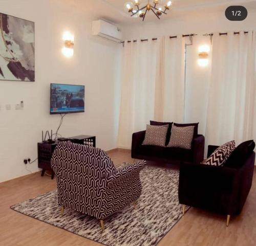a living room with two chairs and a couch at Vancovuer homes in Dodoma