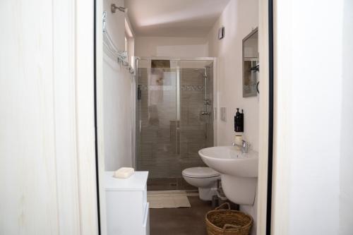 a bathroom with a shower and a toilet and a sink at Ercole B&B in Ugento