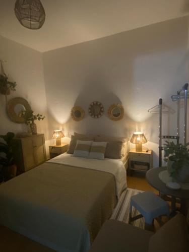 a bedroom with a bed and two tables and two lamps at Studio DKMK in Malia