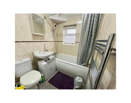 a bathroom with a toilet and a sink and a tub at Wunderschönes Chalet in Oberstdorf mit Berg in Oberstdorf