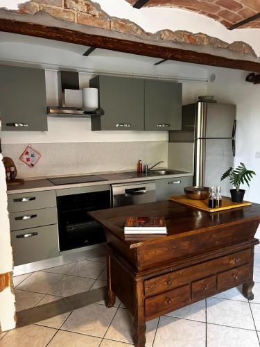 a kitchen with a wooden island in the middle at Casa Didavani 2-6 people in Belveglio