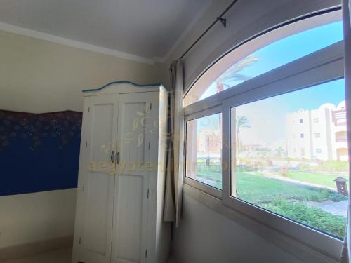 a room with a large window and a door at OrientalCoast Marsa Alam Private Beach in Quseir
