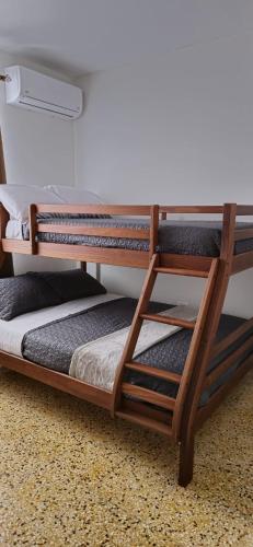 two bunk beds are sitting in a room at D'Ponke Guest House in Cayey
