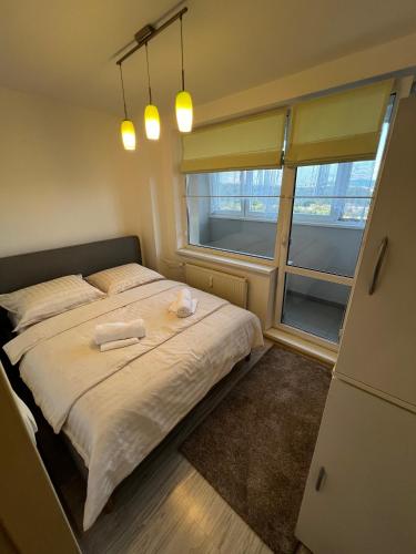 a bedroom with a large bed with two towels on it at Apartmán Košice Nad Jazerom in Košice