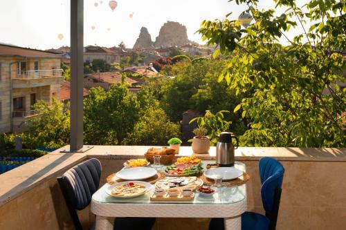 a table with food on top of a balcony at Cappadocia Tughan Stone House in Uçhisar
