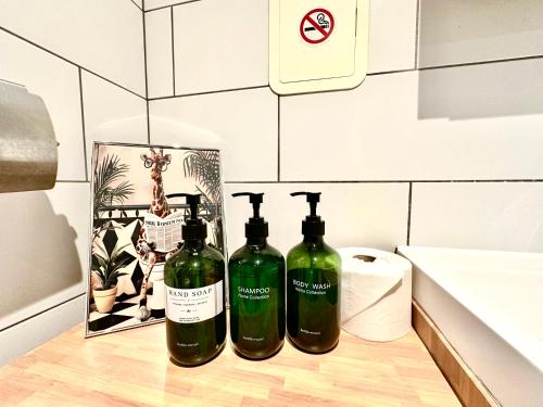 three bottles of wine sitting on top of a counter at Stay in Stratford in London