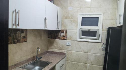 a small kitchen with a sink and a window at Hurghada Sea View Apartment in Hurghada