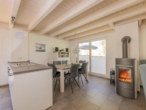 a kitchen and dining room with a fireplace at Villa Milla - Nordhorn in Nordhorn