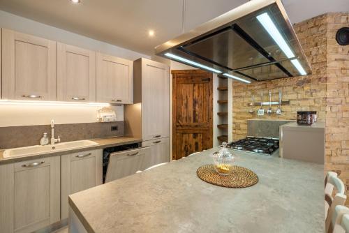 a kitchen with a counter with a sink and a stove at Casa Gradita in Ponte Caffaro