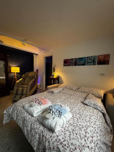 a bedroom with a bed with two pairs of shoes on it at BluePrivateSpa in Latte
