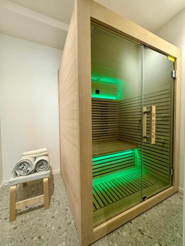 a glass shower with green lights in a room at BluePrivateSpa in Latte