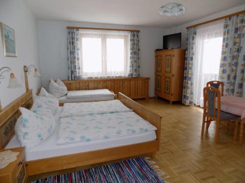 ein Schlafzimmer mit einem Bett, einem Sofa und einem Stuhl in der Unterkunft Eggbauer in Sankt Anton an der Jessnitz