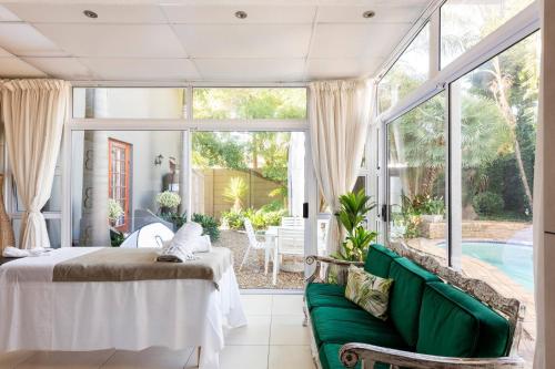 a bedroom with a bed and a couch and a pool at Your homely experience in Paarl