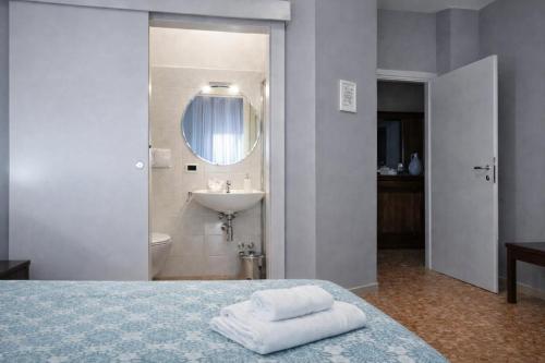 a bathroom with a bed and a sink and a mirror at B&B Residence Armonia Sulmona in Sulmona