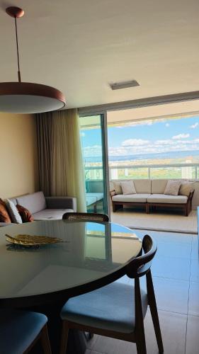 a living room with a table and a couch at flat kariris de luxe in Juazeiro do Norte