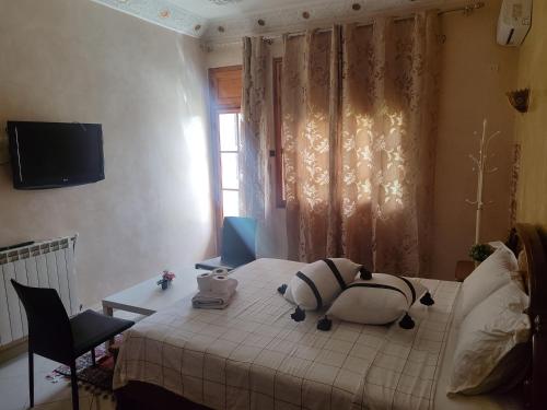 a bedroom with a stuffed animal on a bed at Chambre d'hôte in Midelt