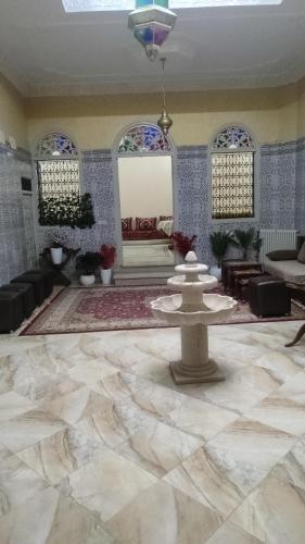 a lobby with a fountain in the middle of a room at Chambre d'hôte in Midelt
