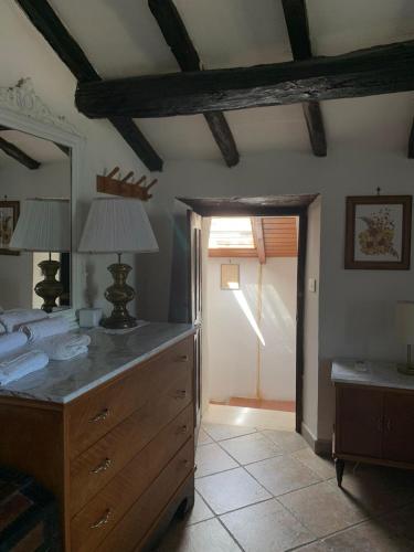 a bedroom with a dresser and a mirror and a door at Il Carpino - Dimora Fresca e parcheggio in Carpineto Romano
