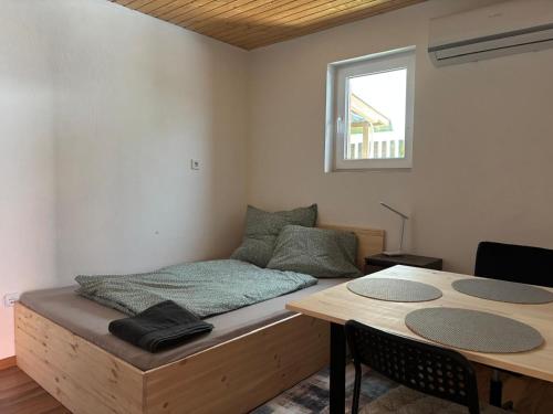 a room with a bed and a table and a table and chairs at Neubeginn 2 - Zimmer B in Hildburghausen