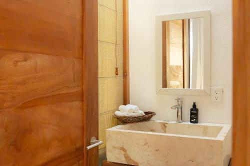 a bathroom with a sink and a mirror at DK Luxury Ocean Front Villa - Adults Only in Holbox Island