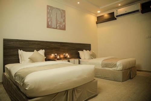a hotel room with two beds in a bedroom at Sky view in Mahlal