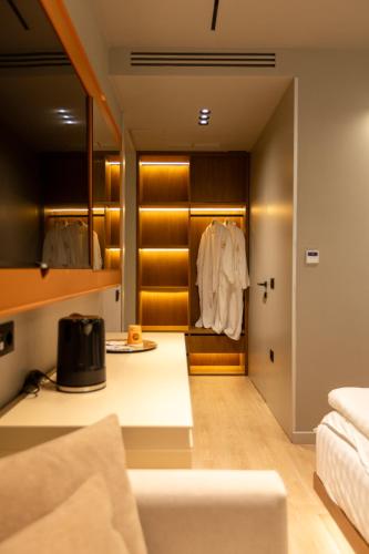 a living room with a couch and a closet at Hotel Berfin in Vlorë