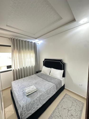 a bedroom with a bed with a towel on it at JULYA appartement centre in Tangier