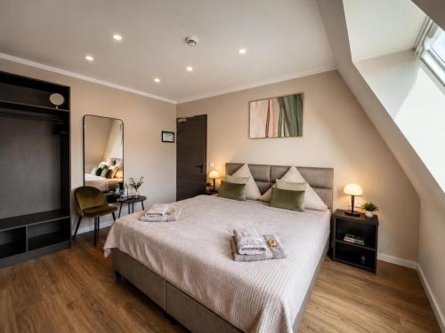 a bedroom with a large bed and a mirror at StadtBlick Hotel in Bad Salzuflen