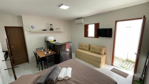 a bedroom with a bed and a desk and a table at Flat em NATAL- RN in Natal