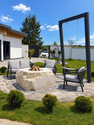 a dog laying in a fountain in a yard at Villa Prestiž in Sokolac