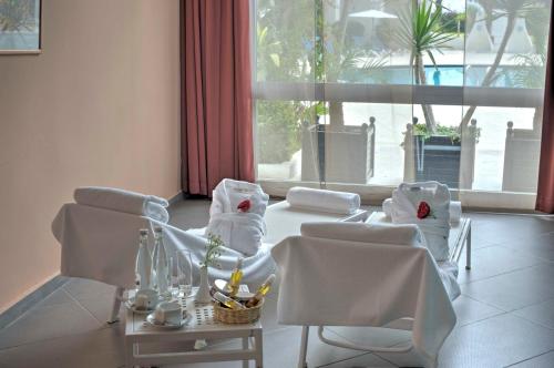a room with chairs and a table and a window at Kenzi Solazur in Tangier