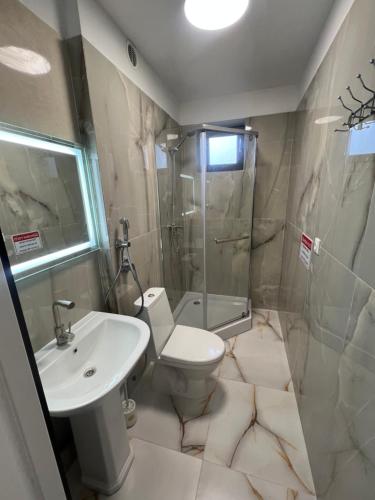 a bathroom with a sink and a toilet and a shower at Котедж GLORIA будинок повністю in Yaremche