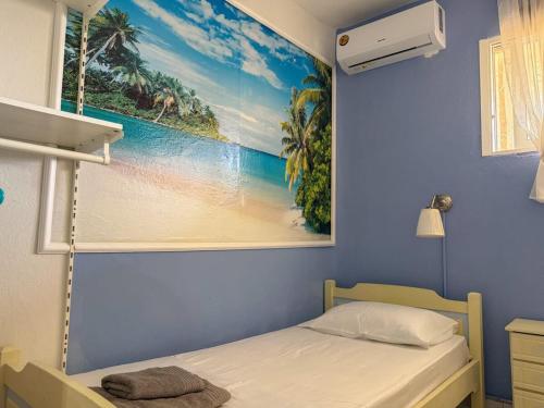 a bedroom with a painting of a beach at Casa Helios Fourka Beach Retreat in Skala Fourkas