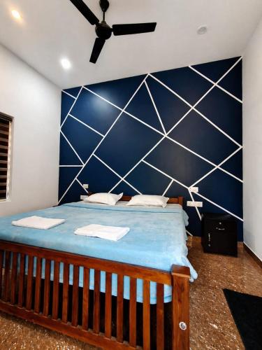 a bedroom with a blue and white wall at Private Pool Villa Vagamon in Vagamon