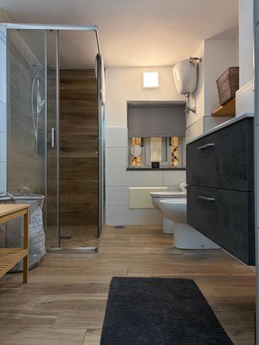a bathroom with a shower and a toilet and a sink at Carpenters Guest House in Pompei