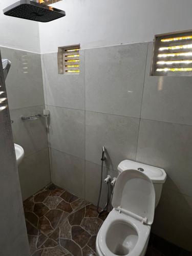 a bathroom with a toilet and a sink at Nimansala Eco Resort in Parakaduwa