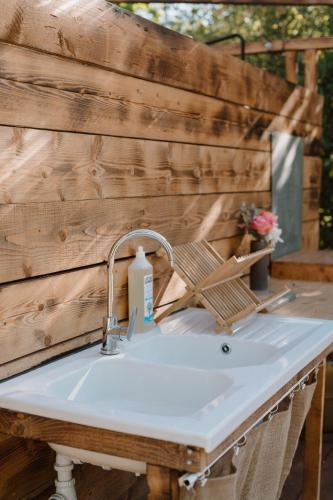 a sink in front of a wooden wall at Le Bunker Secret - Logement Insolite in Florensac