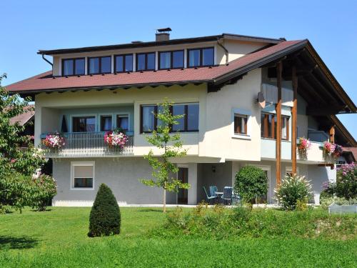 a large house with a red roof at Karglhof Villa in Faak am See