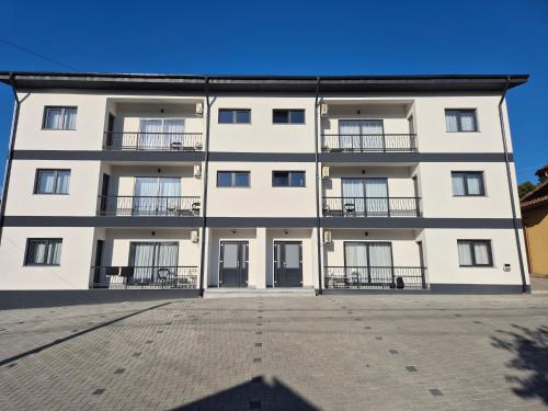 a large white building with balconies on it at Apartament 3D in Fălticeni