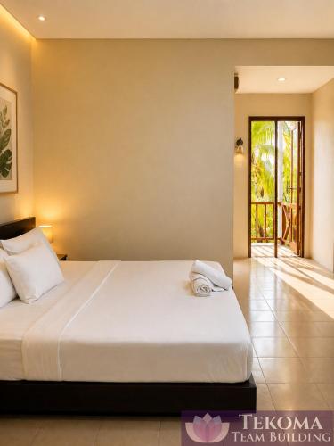 a bedroom with a bed with towels on it at Tekoma Resort Taman Negara in Kuala Tahan