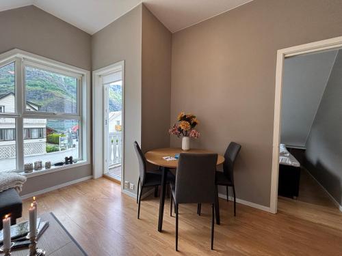 a dining room with a table and chairs at Undredal Fjord Apartments in Undredal