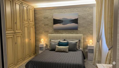 a bedroom with a bed and a painting on the wall at The Dream in Marina di Carrara